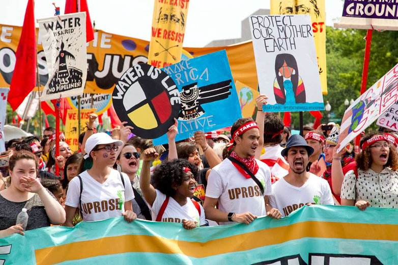 A large group of people holding signs and banners