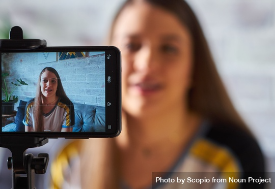 Woman recording a video of heself for social media