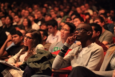 Audience members listening